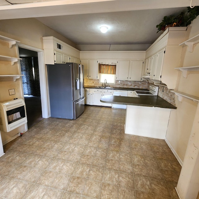 kitchen featuring white appliances, white cabinetry, backsplash, heating unit, and kitchen peninsula