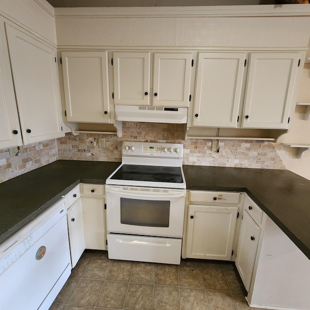 kitchen featuring tile patterned flooring, backsplash, white appliances, and white cabinetry