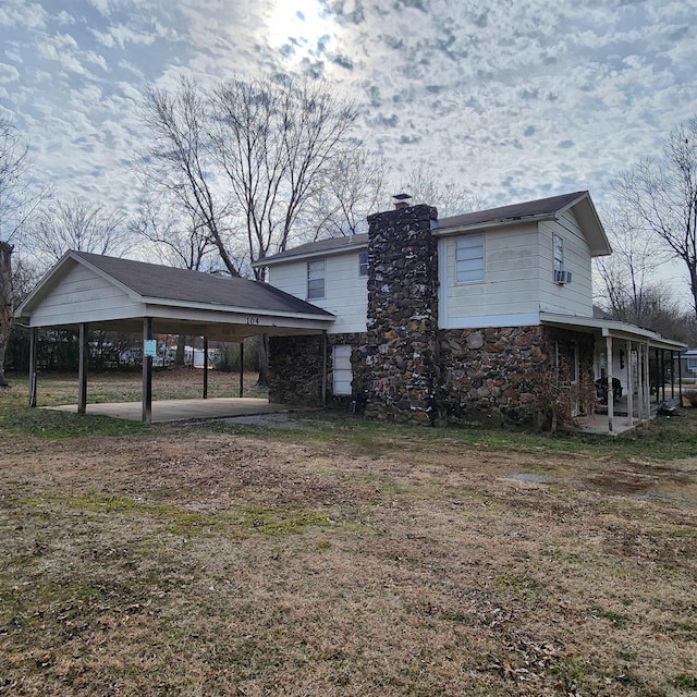 view of side of home with a carport