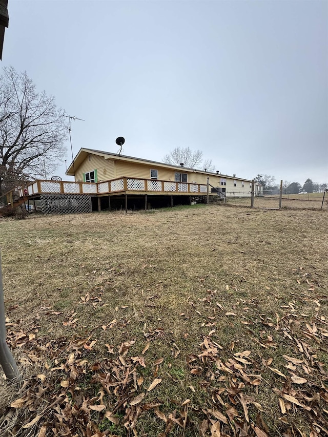 rear view of property featuring a deck