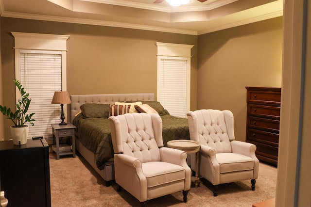 carpeted bedroom featuring ornamental molding, ceiling fan, and a tray ceiling