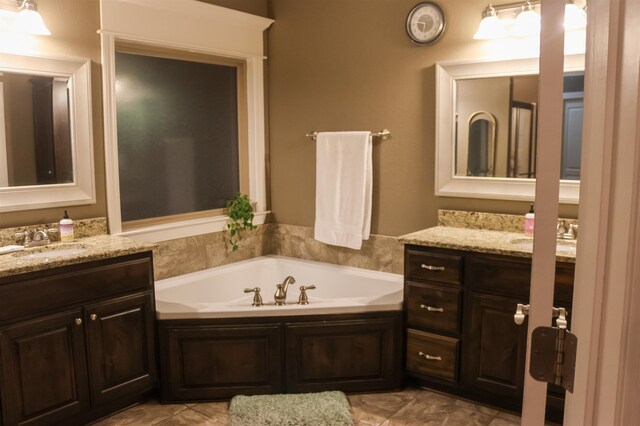 bathroom with vanity and a bath