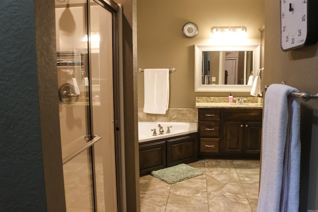 bathroom with tile patterned floors, vanity, and independent shower and bath