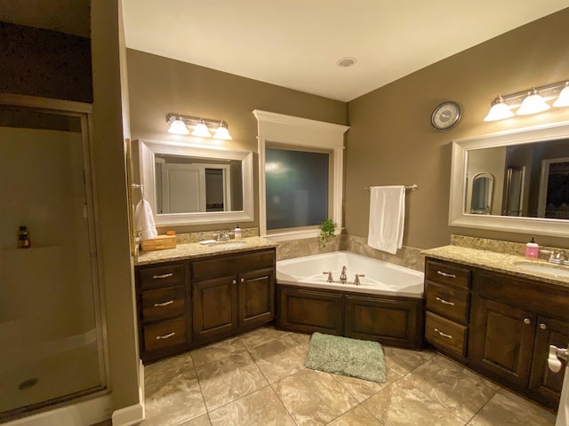 bathroom featuring independent shower and bath and vanity