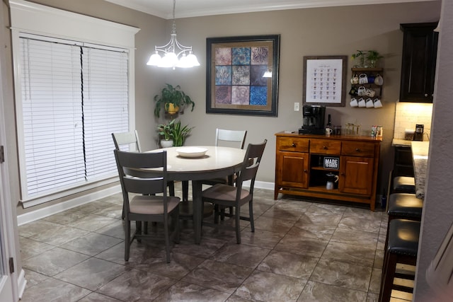 dining area featuring ornamental molding and a chandelier