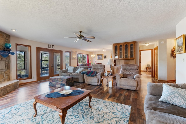 living room with ceiling fan, hardwood / wood-style floors, a textured ceiling, and french doors