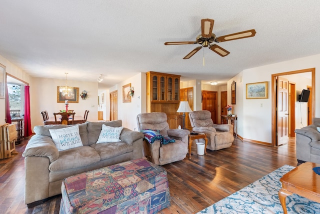 living room with ceiling fan, dark hardwood / wood-style floors, and a textured ceiling