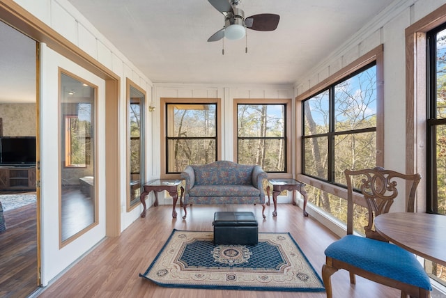 sunroom / solarium with a wealth of natural light and ceiling fan