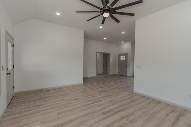 spare room with ceiling fan, lofted ceiling, and light hardwood / wood-style floors