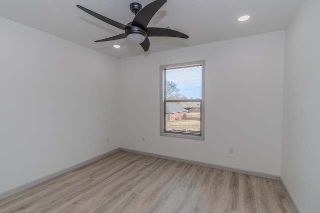 empty room featuring ceiling fan and light hardwood / wood-style flooring