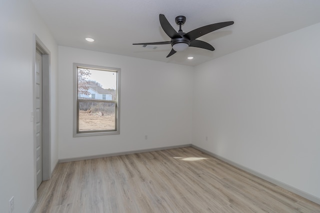 empty room featuring ceiling fan and light hardwood / wood-style flooring