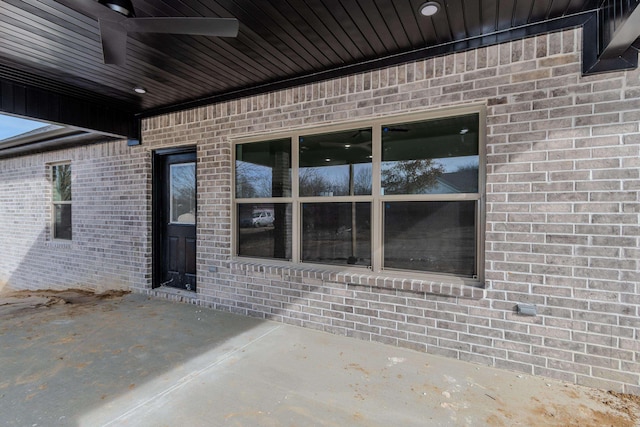 entrance to property featuring a patio and ceiling fan