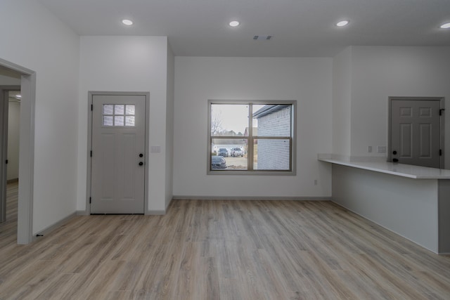 entrance foyer featuring plenty of natural light and light hardwood / wood-style floors