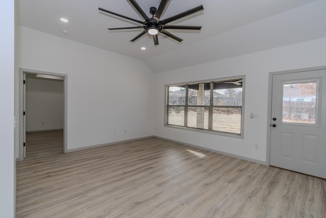 foyer featuring light hardwood / wood-style flooring, vaulted ceiling, and ceiling fan