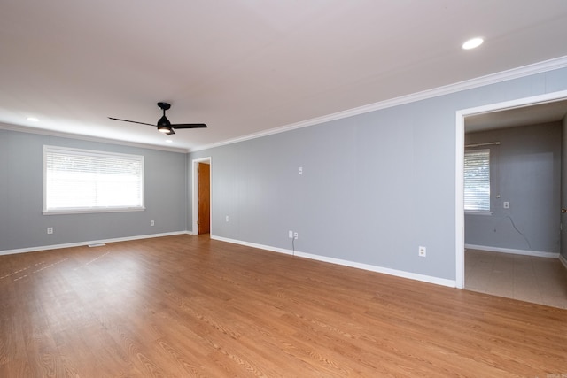 unfurnished room featuring crown molding, light hardwood / wood-style flooring, and plenty of natural light