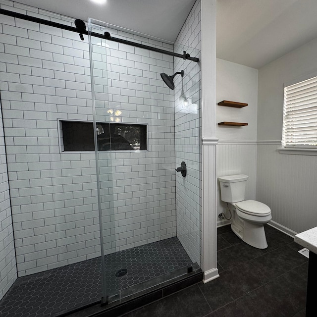 bathroom featuring vanity, a shower with shower door, tile patterned floors, and toilet