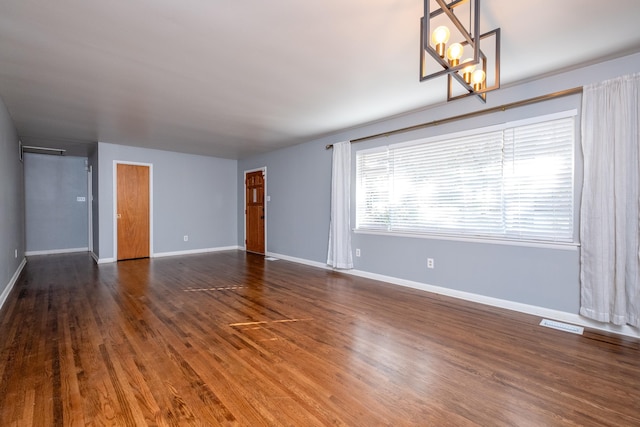 unfurnished room with dark hardwood / wood-style flooring