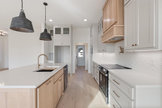 kitchen with sink, pendant lighting, stainless steel dishwasher, electric stove, and white cabinets