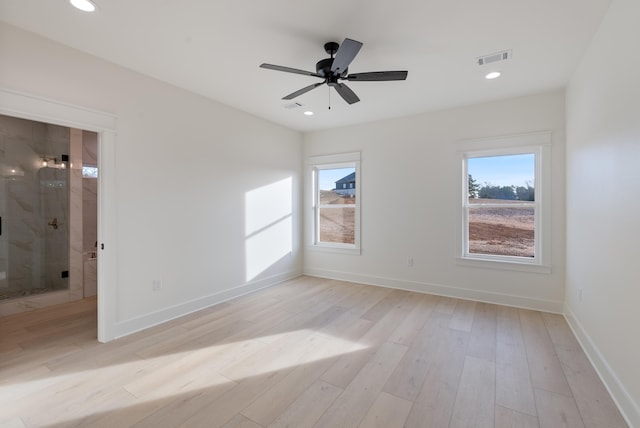 spare room featuring light hardwood / wood-style floors and ceiling fan