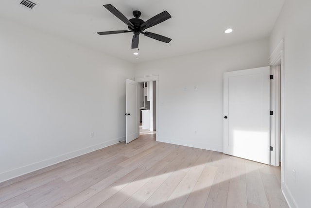 unfurnished bedroom with ceiling fan and light wood-type flooring