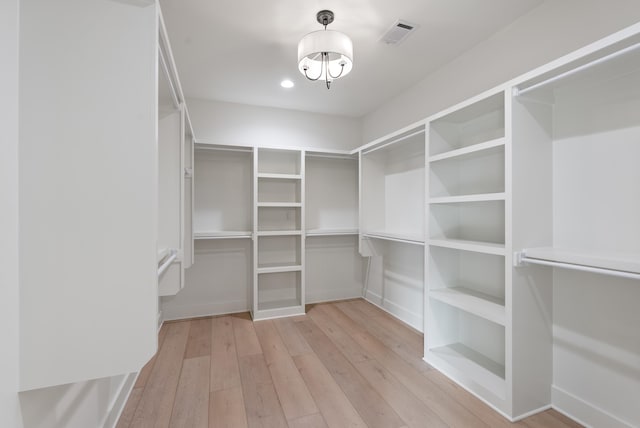 walk in closet featuring light hardwood / wood-style floors