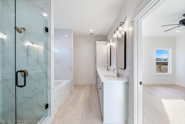 bathroom with vanity, wood-type flooring, ceiling fan, and separate shower and tub