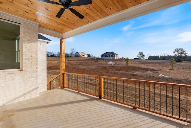 wooden terrace with a rural view and ceiling fan