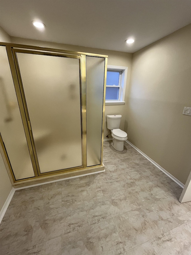 bathroom with an enclosed shower and toilet