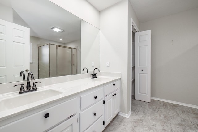 bathroom featuring vanity and an enclosed shower