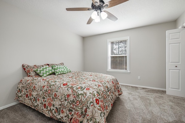 carpeted bedroom with ceiling fan and a textured ceiling