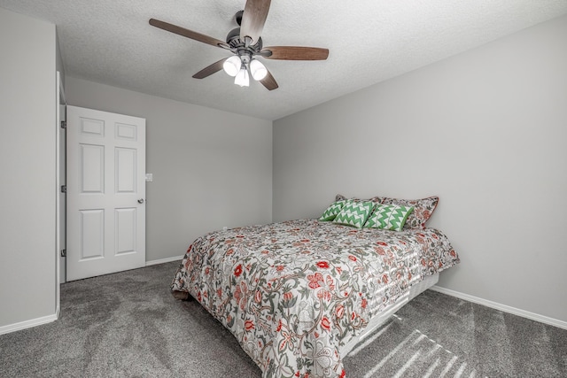 carpeted bedroom featuring ceiling fan and a textured ceiling