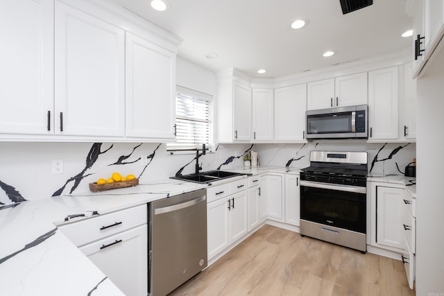 kitchen featuring white cabinetry, appliances with stainless steel finishes, and sink