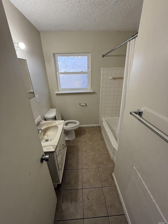 full bathroom with tile patterned flooring, vanity, a textured ceiling, and toilet