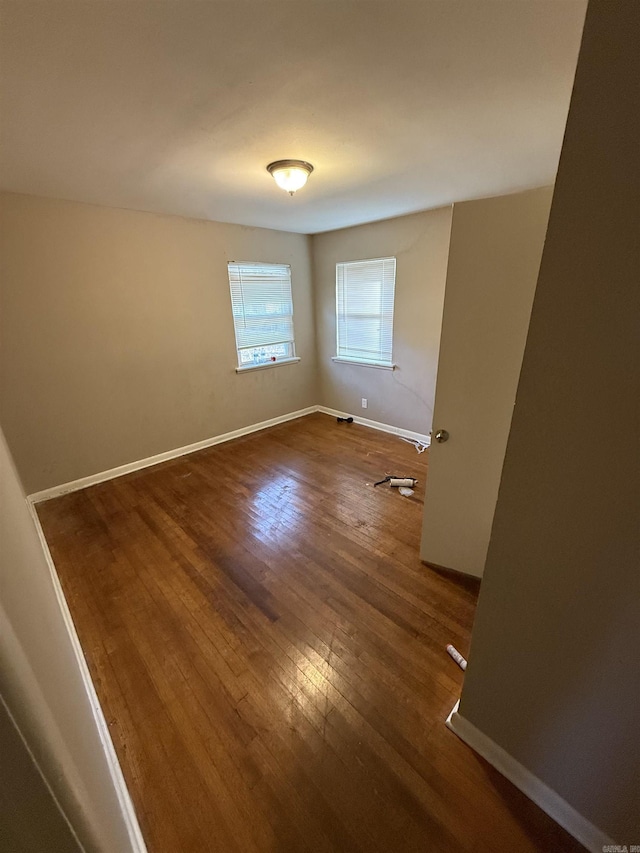 unfurnished room with dark hardwood / wood-style floors