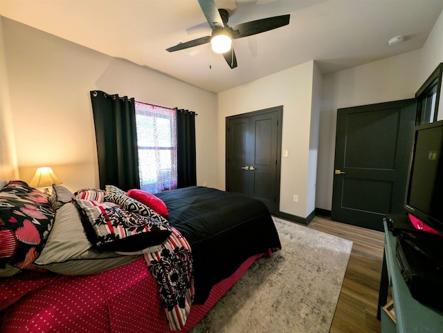 bedroom with hardwood / wood-style flooring and ceiling fan