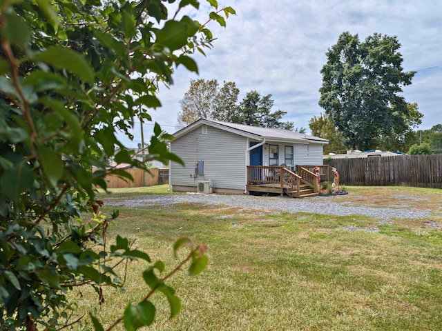 back of house with a yard and a deck