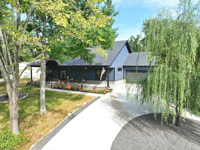 view of front of house featuring a garage and a front lawn