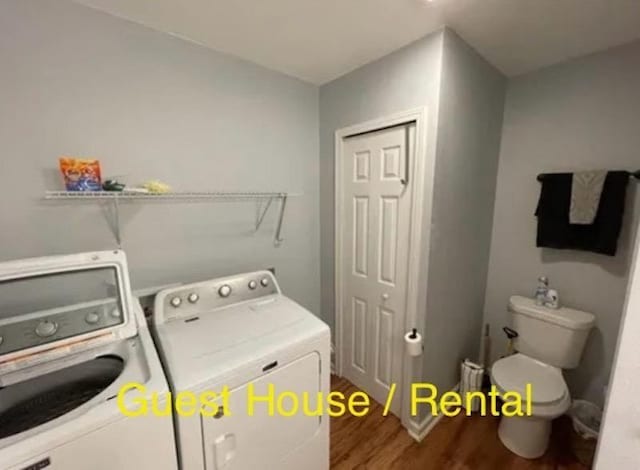 laundry area with separate washer and dryer and dark hardwood / wood-style floors