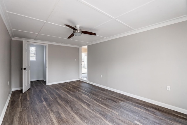 spare room featuring crown molding, ceiling fan, dark hardwood / wood-style flooring, and a wealth of natural light