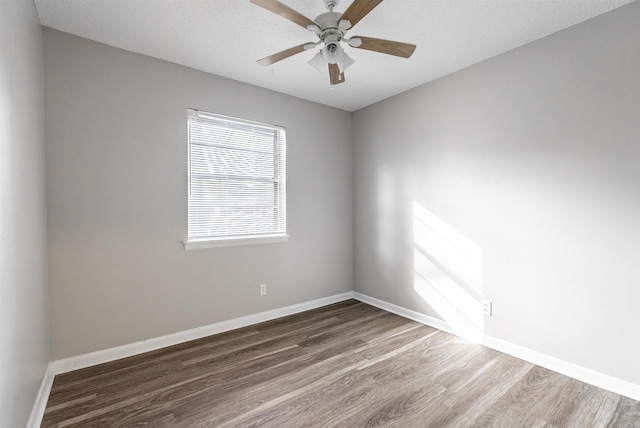 empty room with dark wood-type flooring, a textured ceiling, and ceiling fan