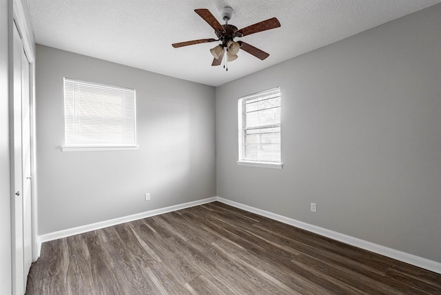 spare room featuring ceiling fan, a textured ceiling, and dark hardwood / wood-style flooring