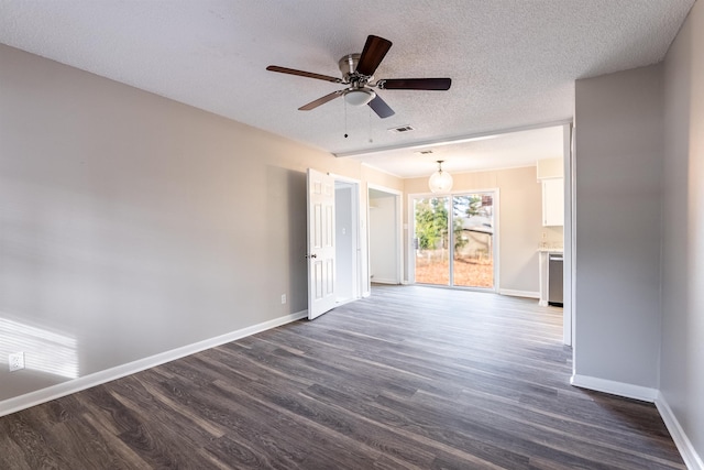 empty room with ceiling fan, dark wood-type flooring, and a textured ceiling