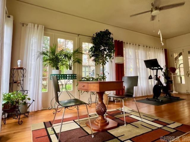 sunroom / solarium featuring ceiling fan