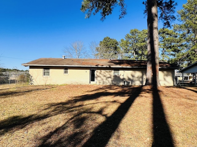 exterior space featuring a yard and central AC