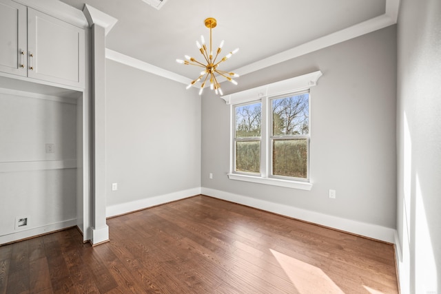 unfurnished bedroom featuring dark wood-type flooring, ornamental molding, and a chandelier