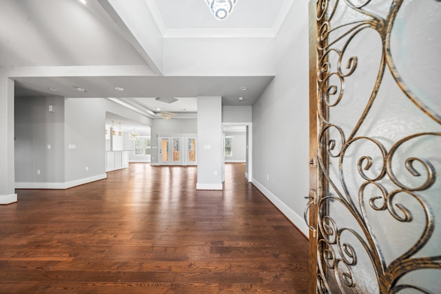 entryway featuring crown molding, dark hardwood / wood-style floors, and an inviting chandelier