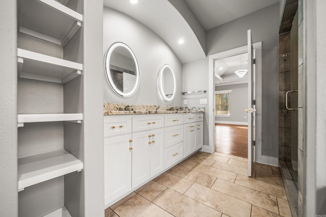 bathroom with tile patterned flooring, vanity, and a shower with shower door