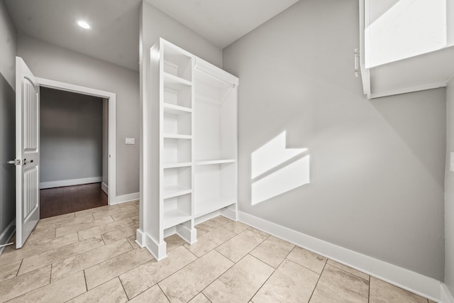 walk in closet with light tile patterned floors