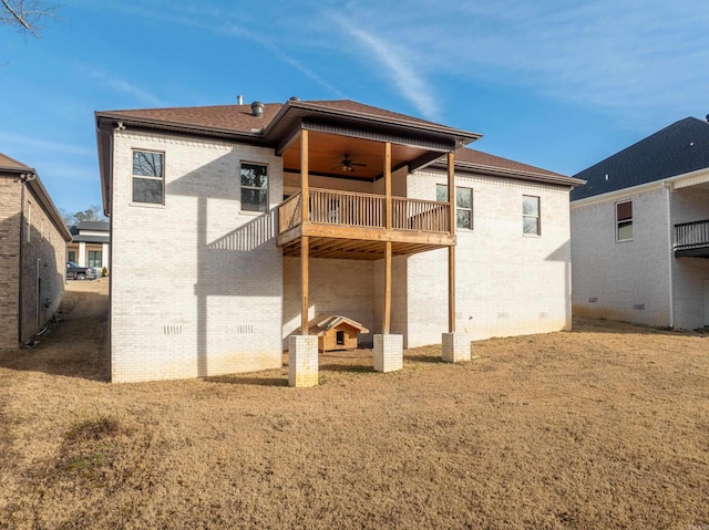 back of house featuring ceiling fan, a yard, and a balcony