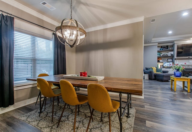 dining area with ornamental molding, dark hardwood / wood-style floors, and a chandelier